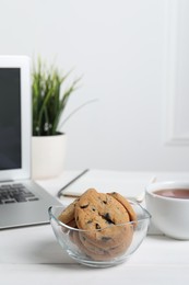 Chocolate chip cookies on white wooden table in office