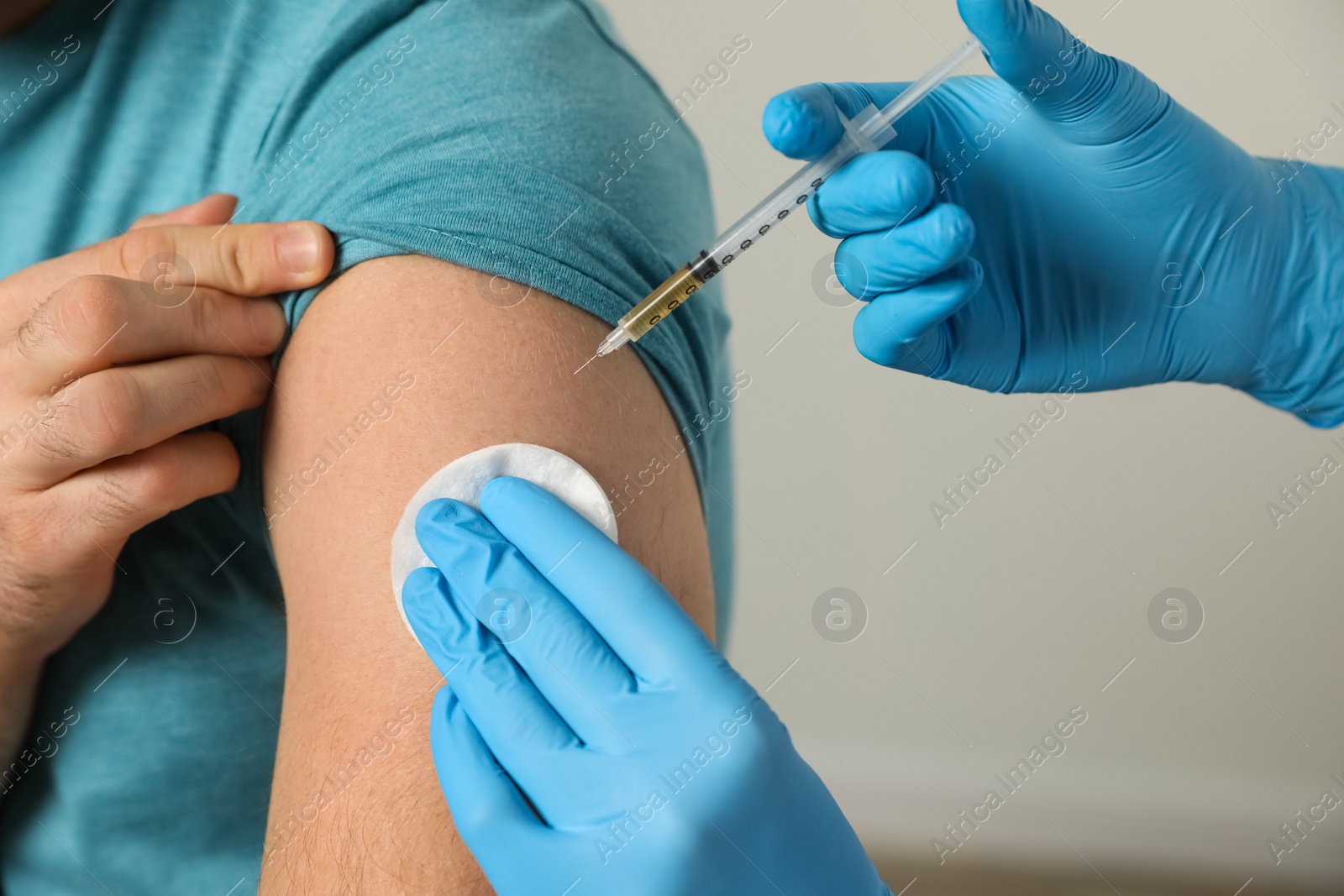 Photo of Doctor giving injection to patient in hospital, closeup. Vaccination day