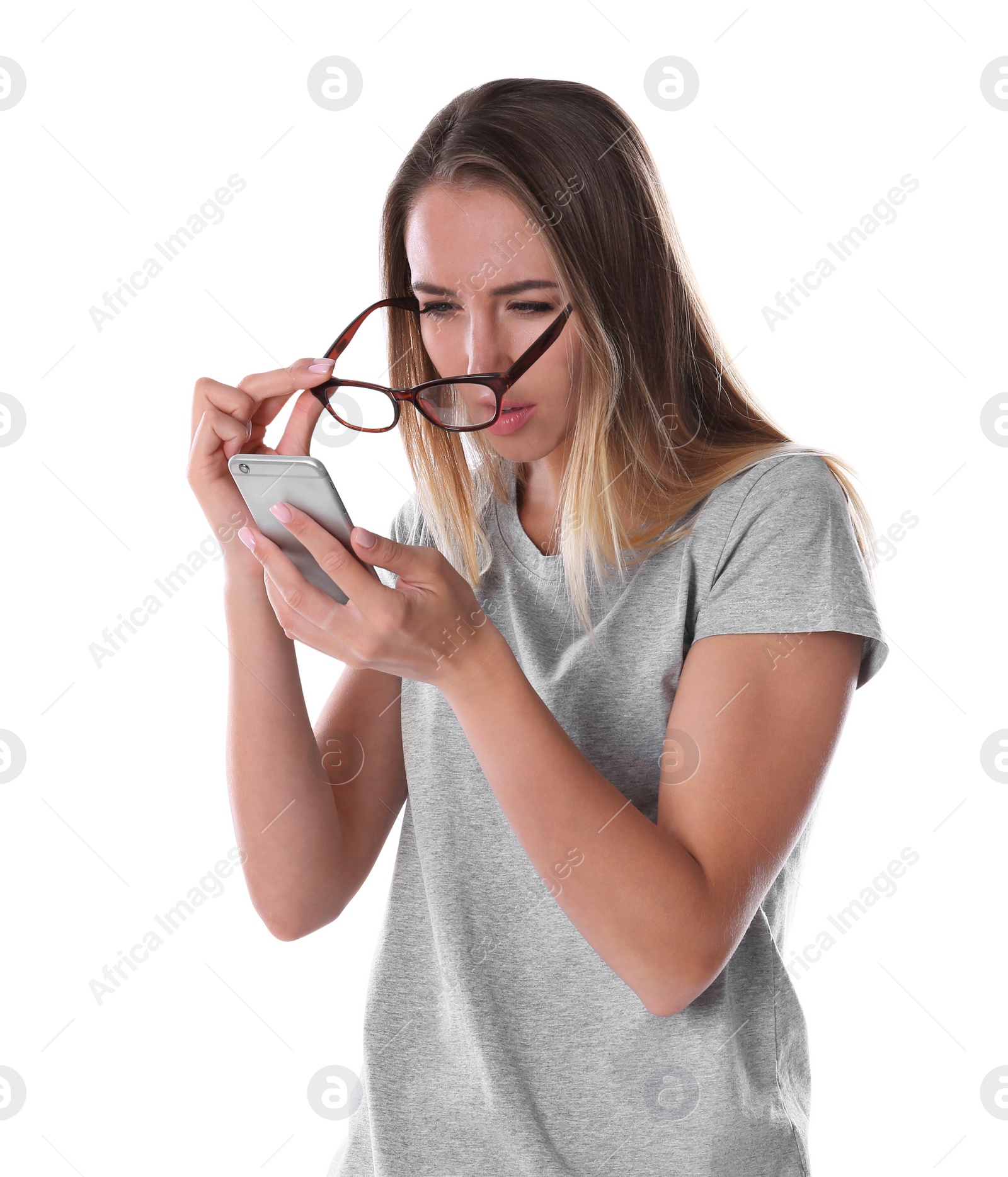 Photo of Young woman with glasses using mobile phone on white background. Vision problem