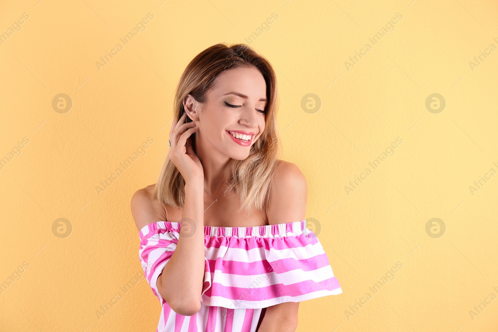 Photo of Portrait of beautiful laughing woman on color background