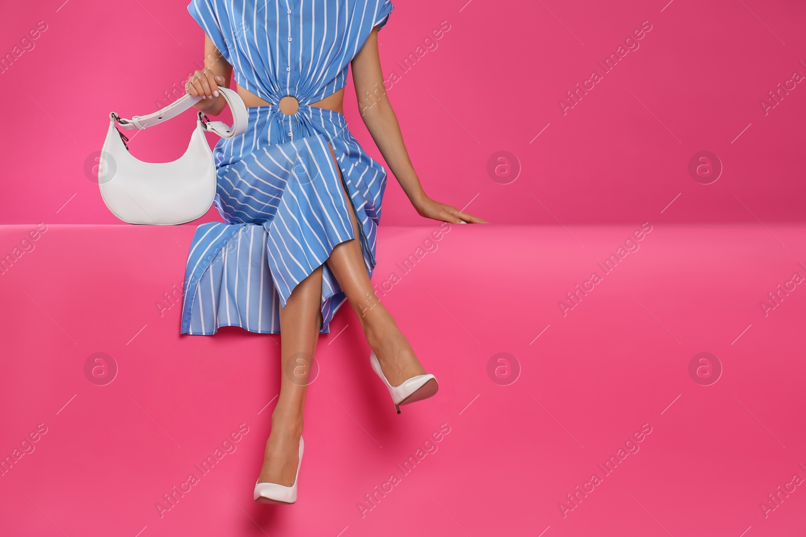 Photo of Woman with stylish bag on pink background, closeup. Space for text