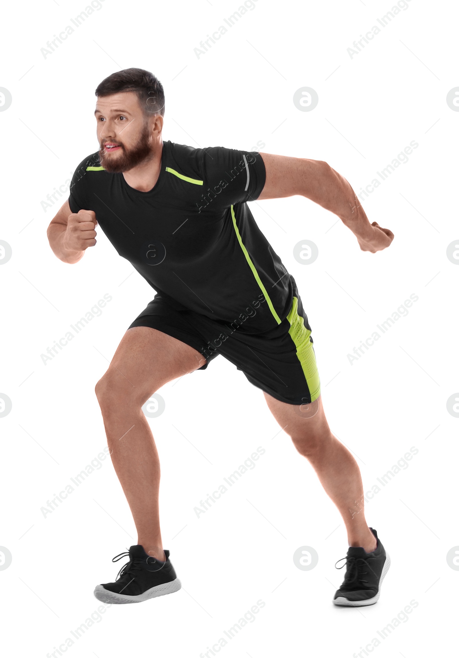 Photo of Young man in sportswear running on white background