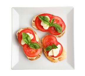 Photo of Tasty fresh tomato bruschettas on white background, top view