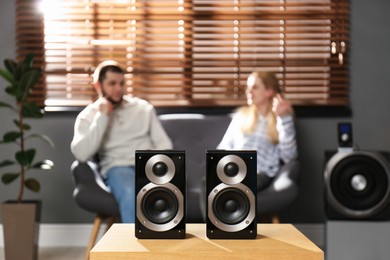 Photo of People enjoying music with modern audio speaker system in living room