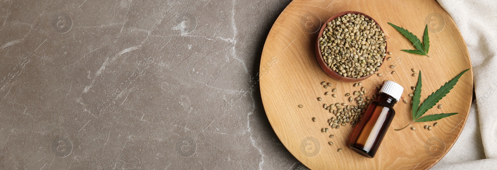 Image of Flat lay composition with bottle of hemp oil and space for text on table, banner design