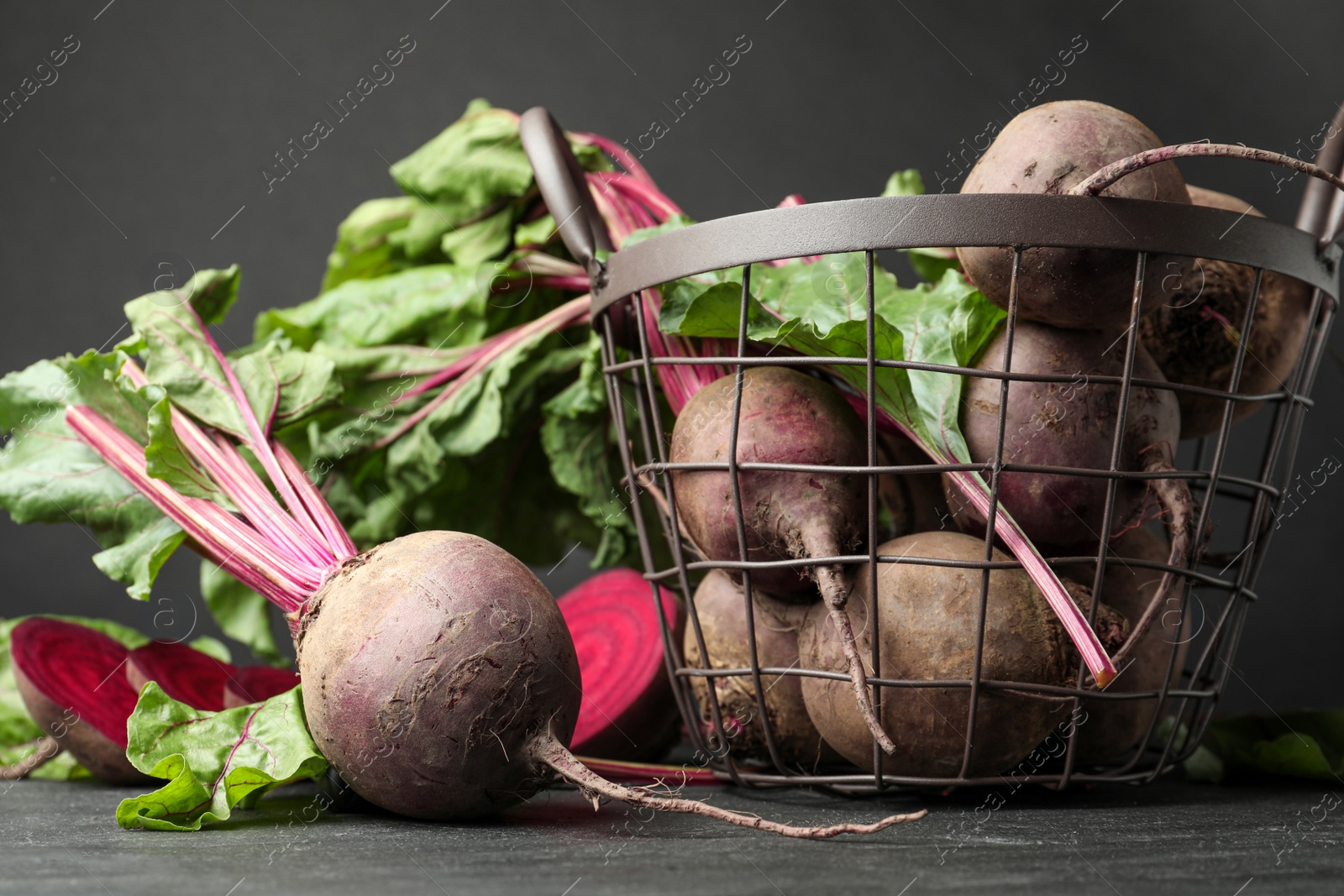 Photo of Whole ripe beets on black table. Organic vegetable