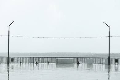 Empty city embankment on grey rainy day