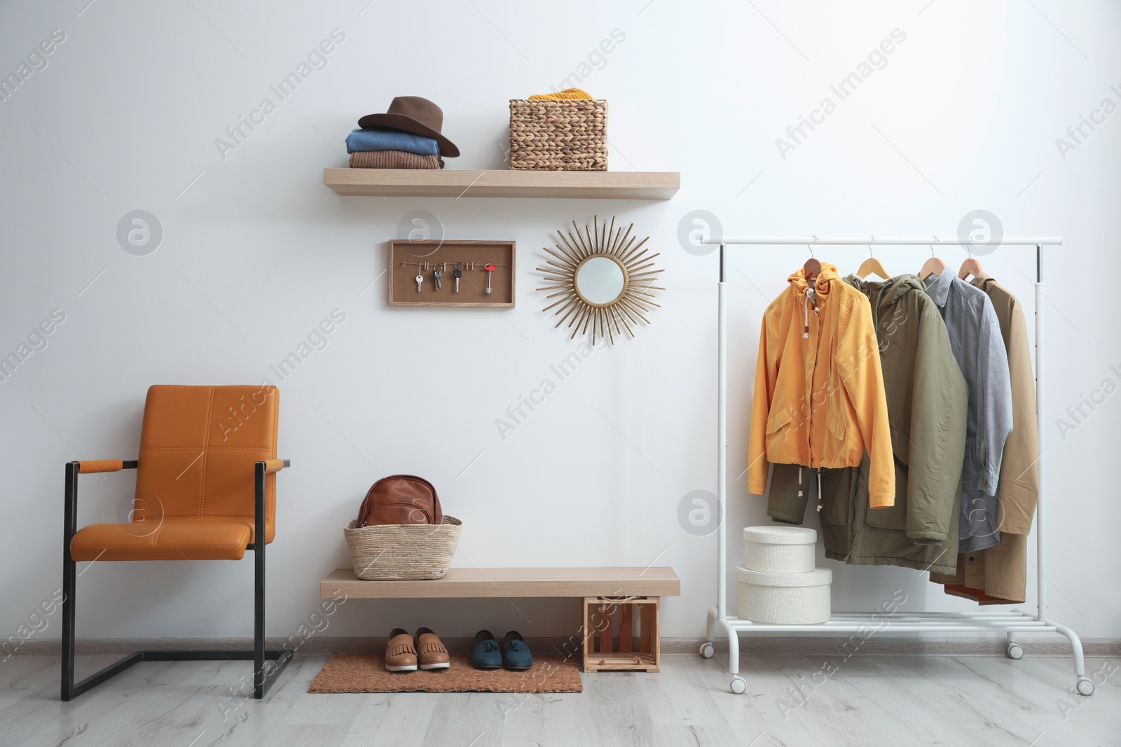 Photo of Hallway interior with stylish furniture, clothes and accessories
