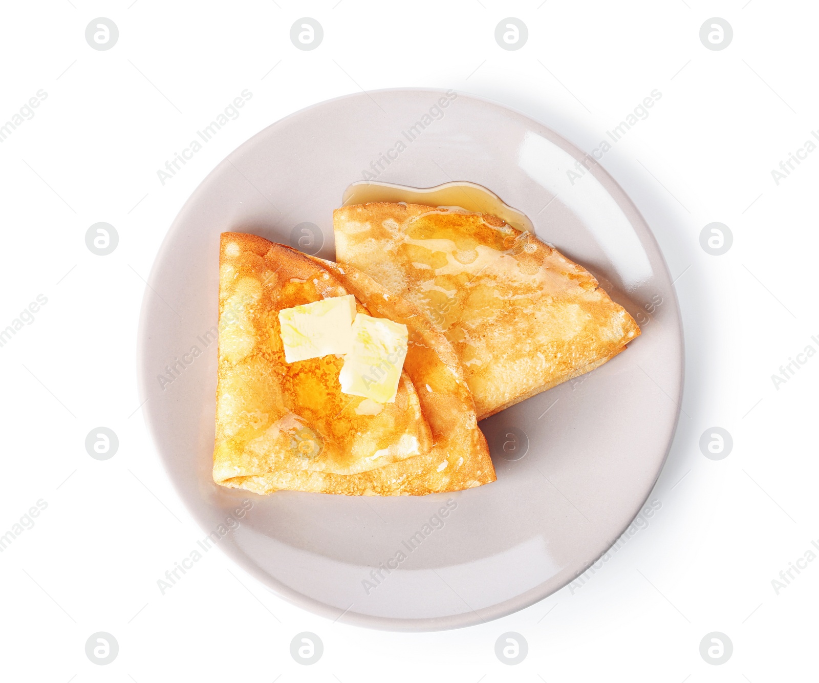 Photo of Plate with tasty thin pancakes, butter and maple syrup on white background, top view