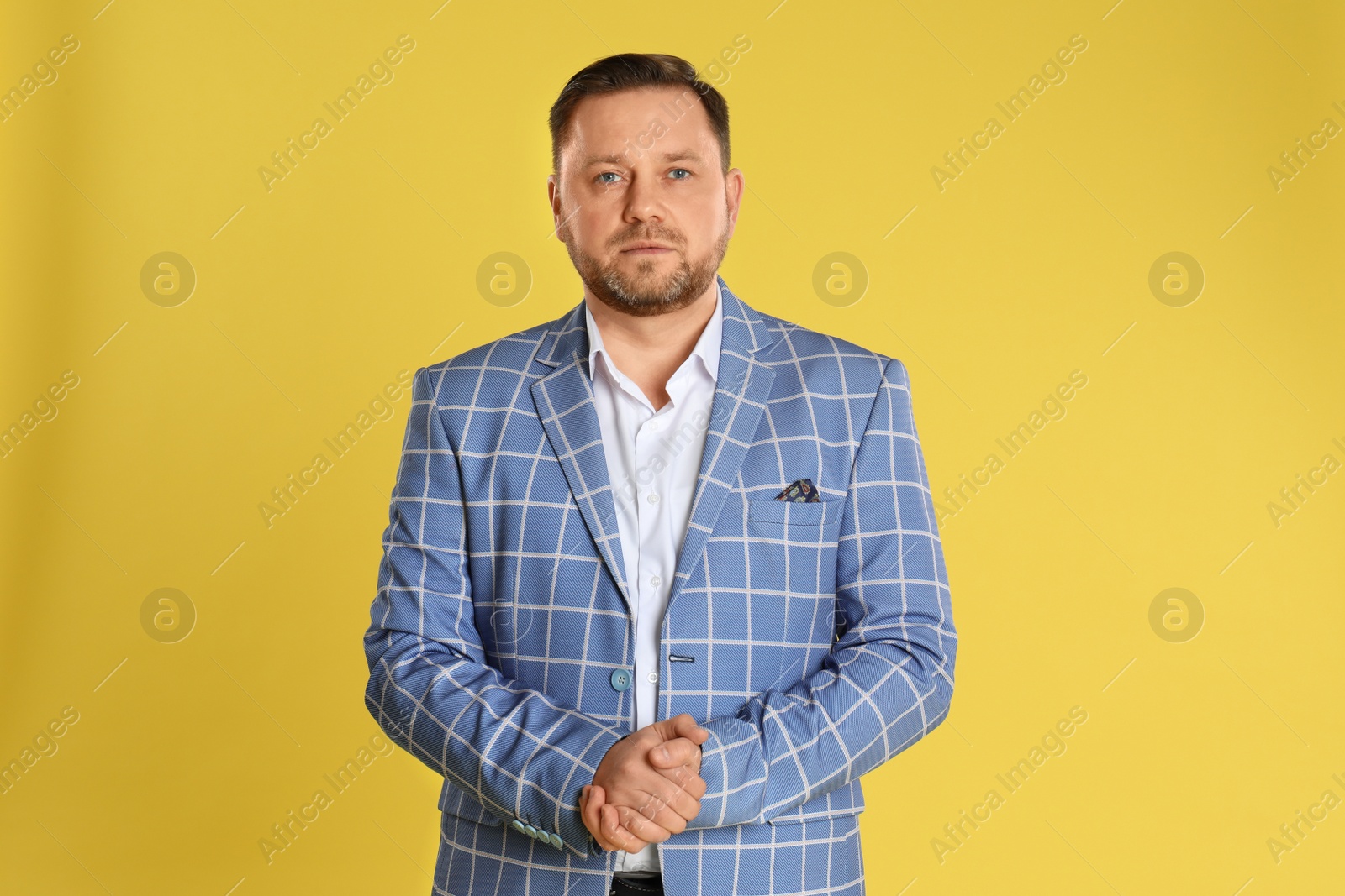 Photo of Portrait of mature man on yellow background