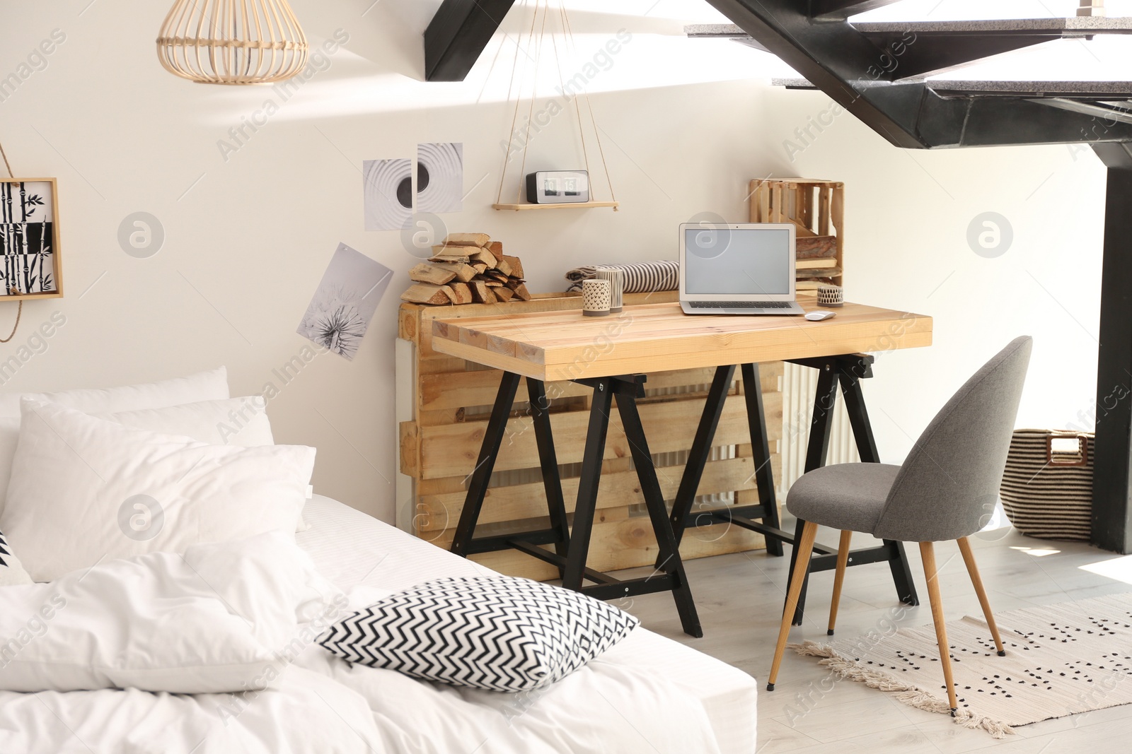 Photo of Elegant interior of bedroom with workplace under stairs