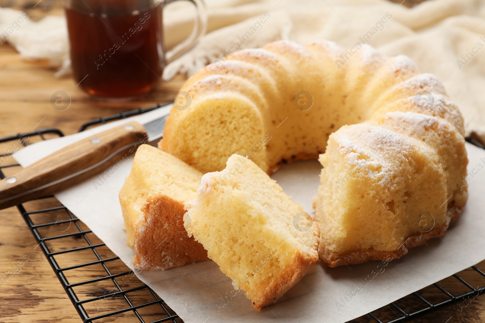 Photo of Delicious freshly baked sponge cake on wooden table, closeup