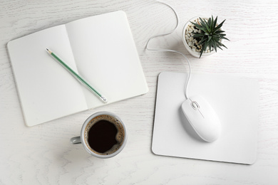 Photo of Flat lay composition with mouse and cup of coffee on white wooden table