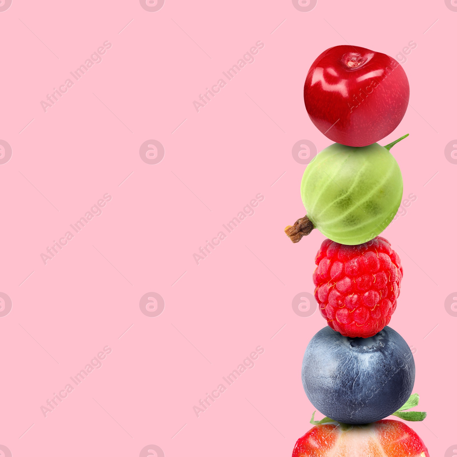 Image of Stack of different fresh tasty berries and cherry on pink background, space for text