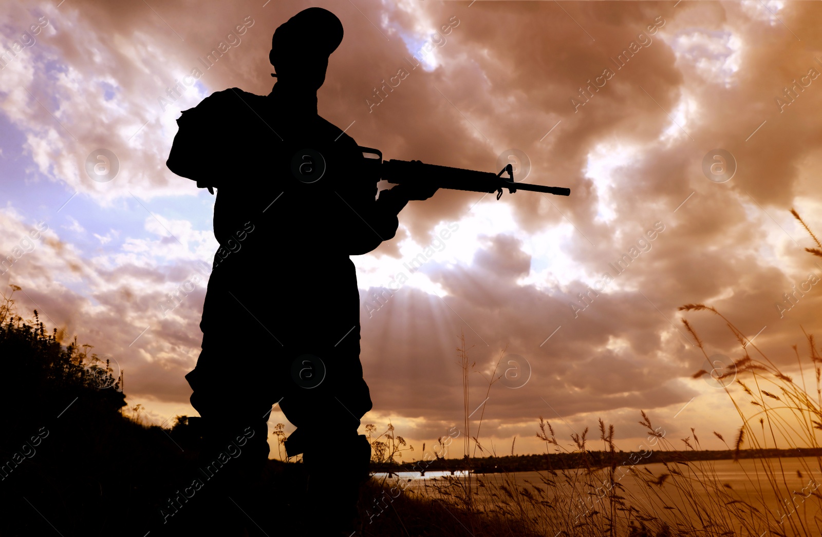 Photo of Soldier with machine gun patrolling outdoors. Military service