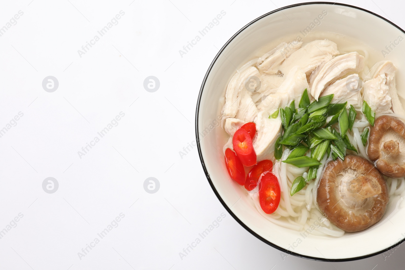 Photo of Delicious ramen with meat and mushrooms in bowl on white background, top view. Space for text