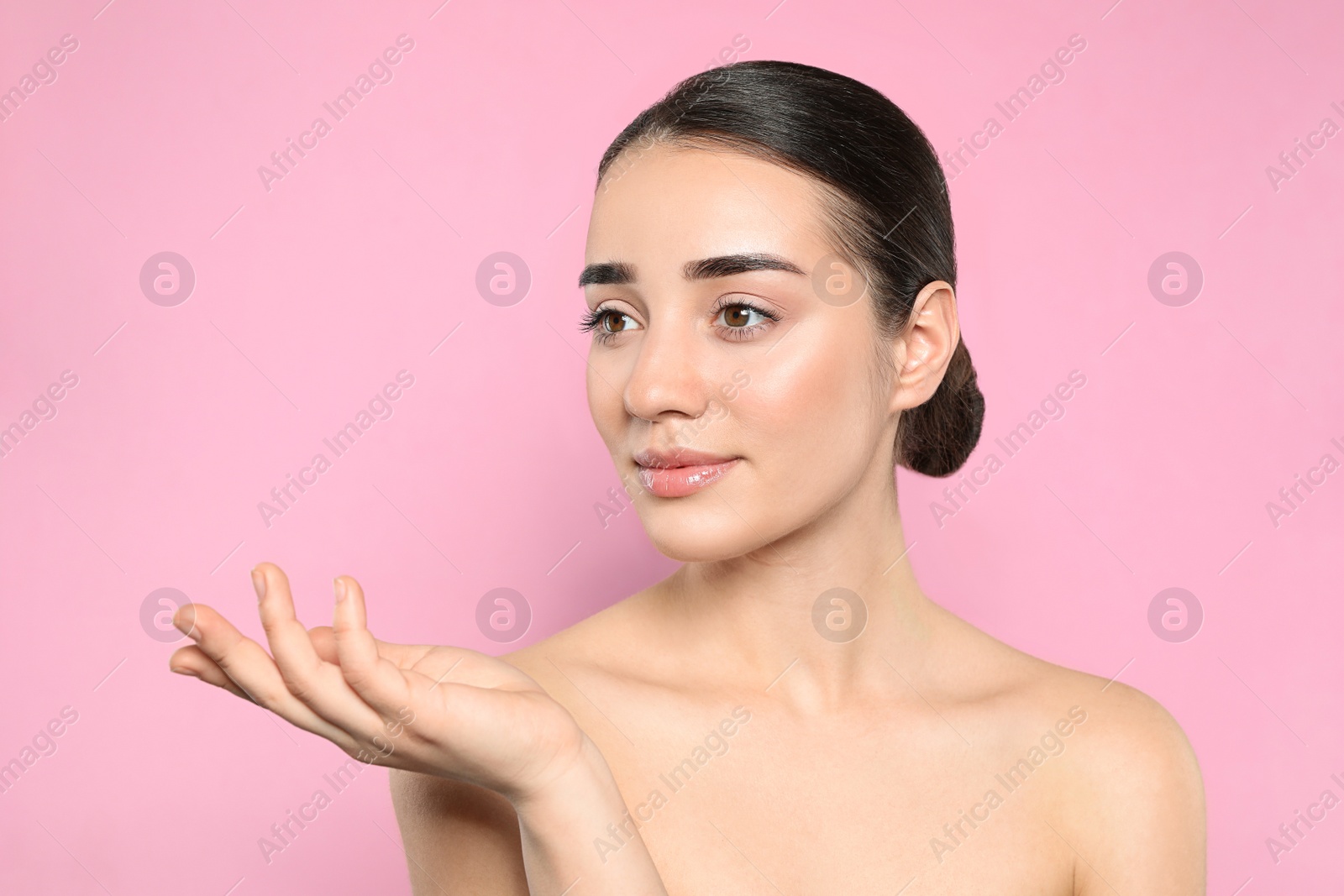 Photo of Portrait of young woman with beautiful face against color background