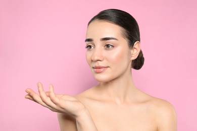 Portrait of young woman with beautiful face against color background