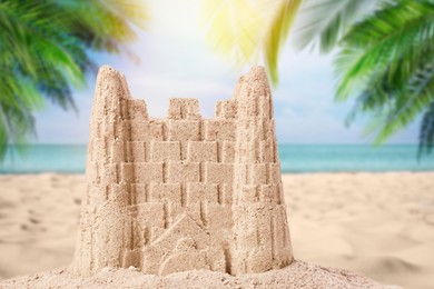 Image of Sand castle on ocean beach, closeup. Outdoor play