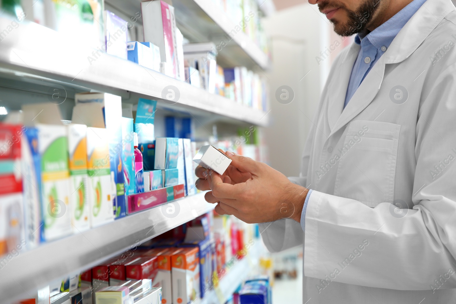 Image of Professional pharmacist with medicine in drugstore, closeup