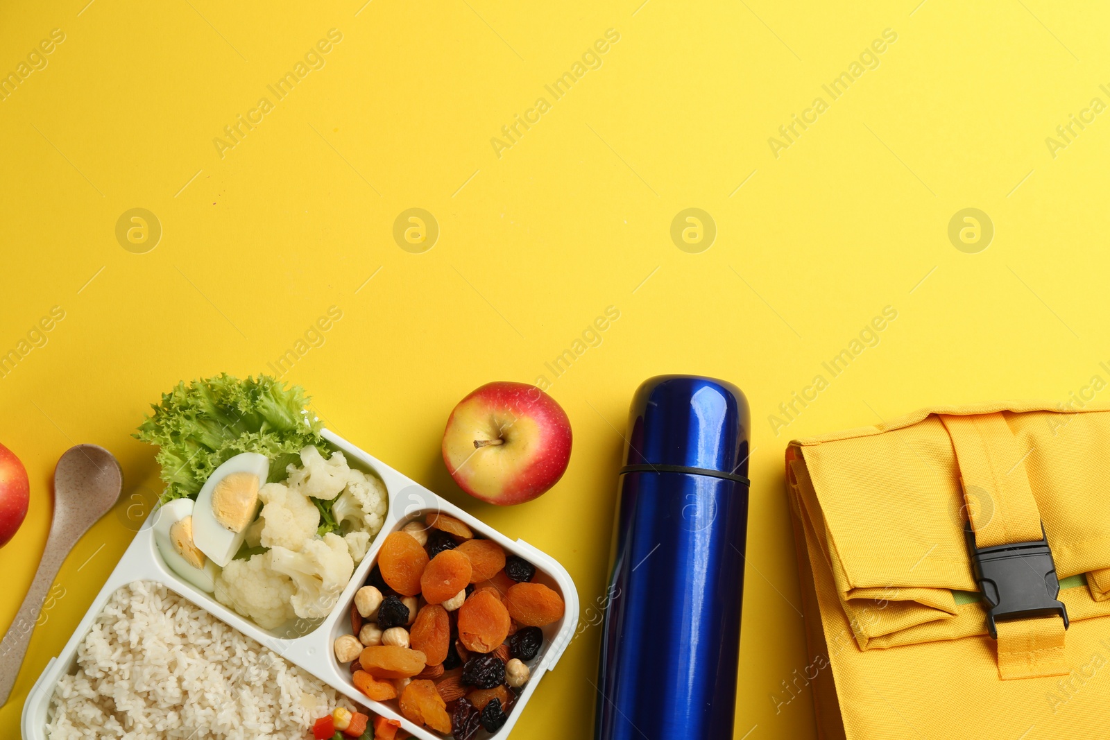 Photo of Flat lay composition with thermos and food on yellow background. Space for text