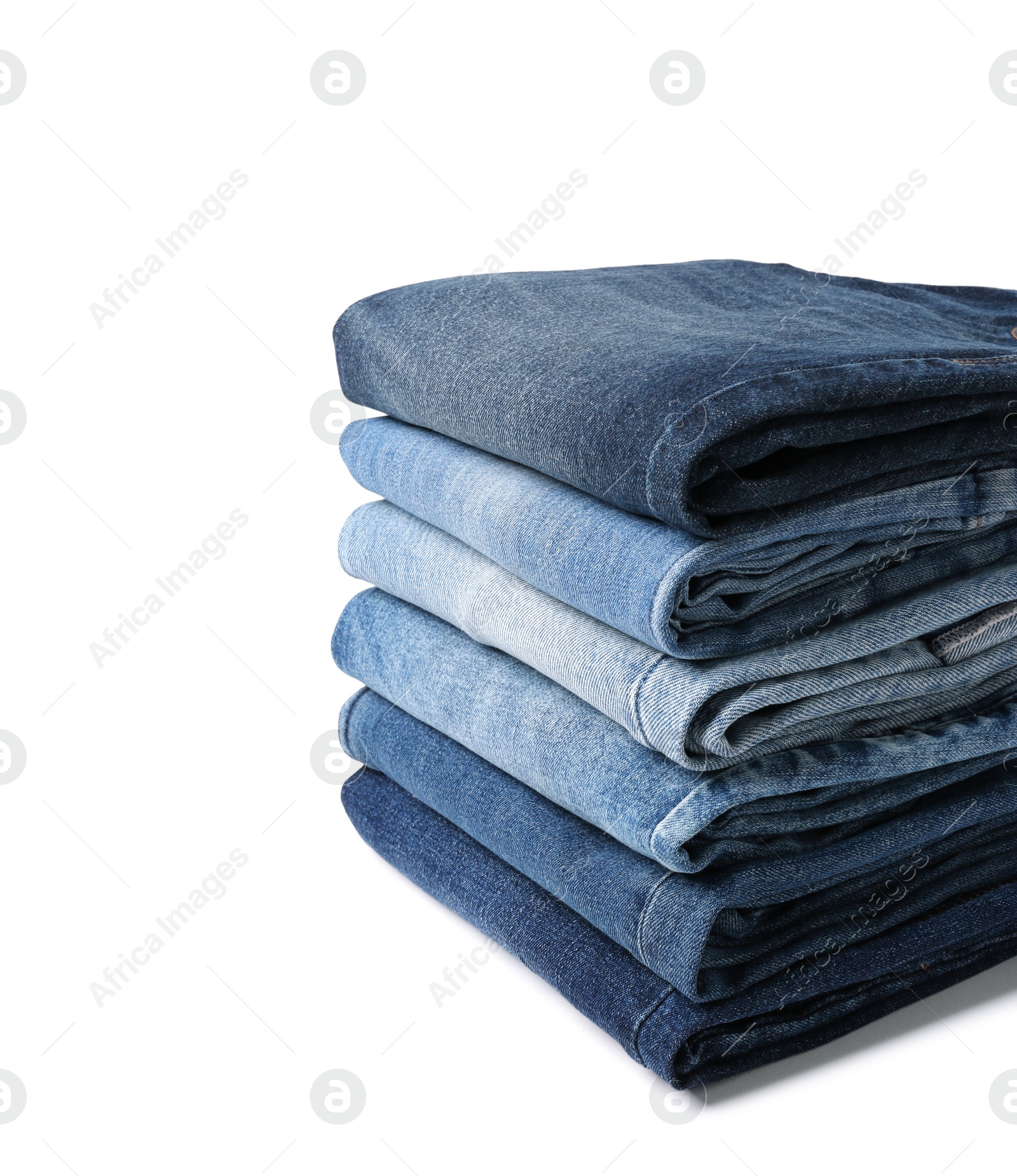 Image of Stacks of different folded jeans isolated on white