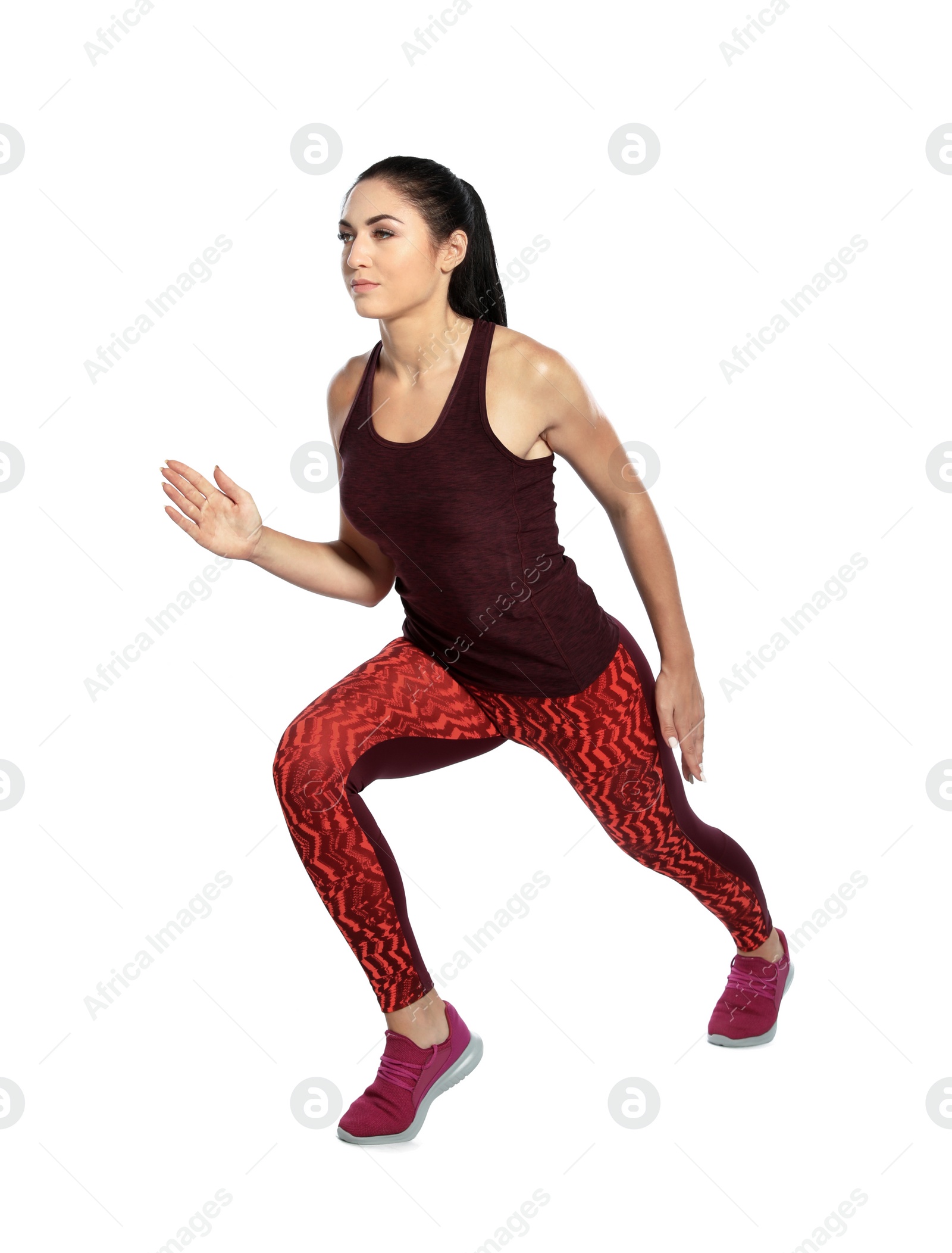 Photo of Young female runner exercising on white background