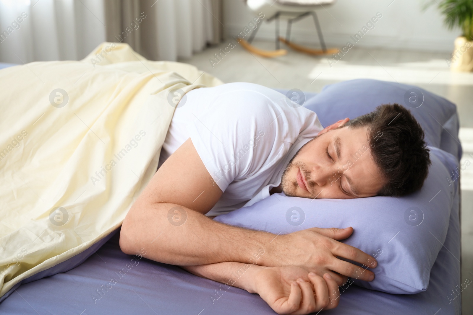 Photo of Handsome man sleeping on pillow at home. Bedtime