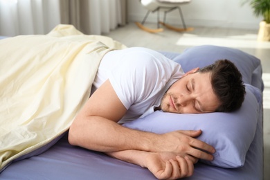 Handsome man sleeping on pillow at home. Bedtime