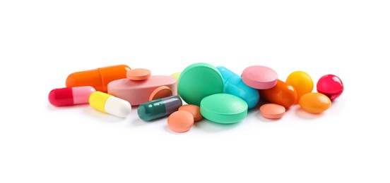 Pile of different colorful pills on white background