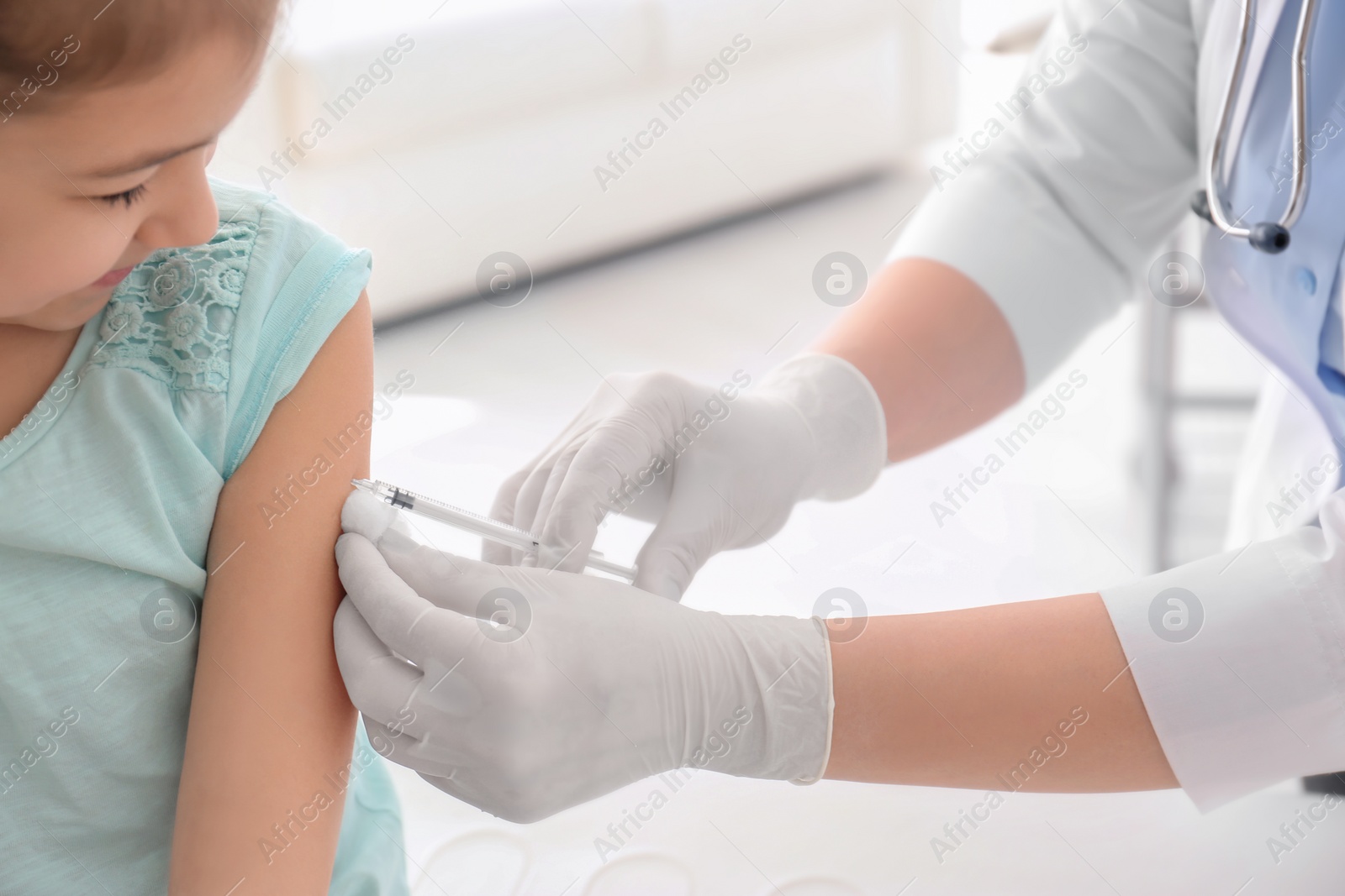 Photo of Doctor vaccinating little girl in hospital