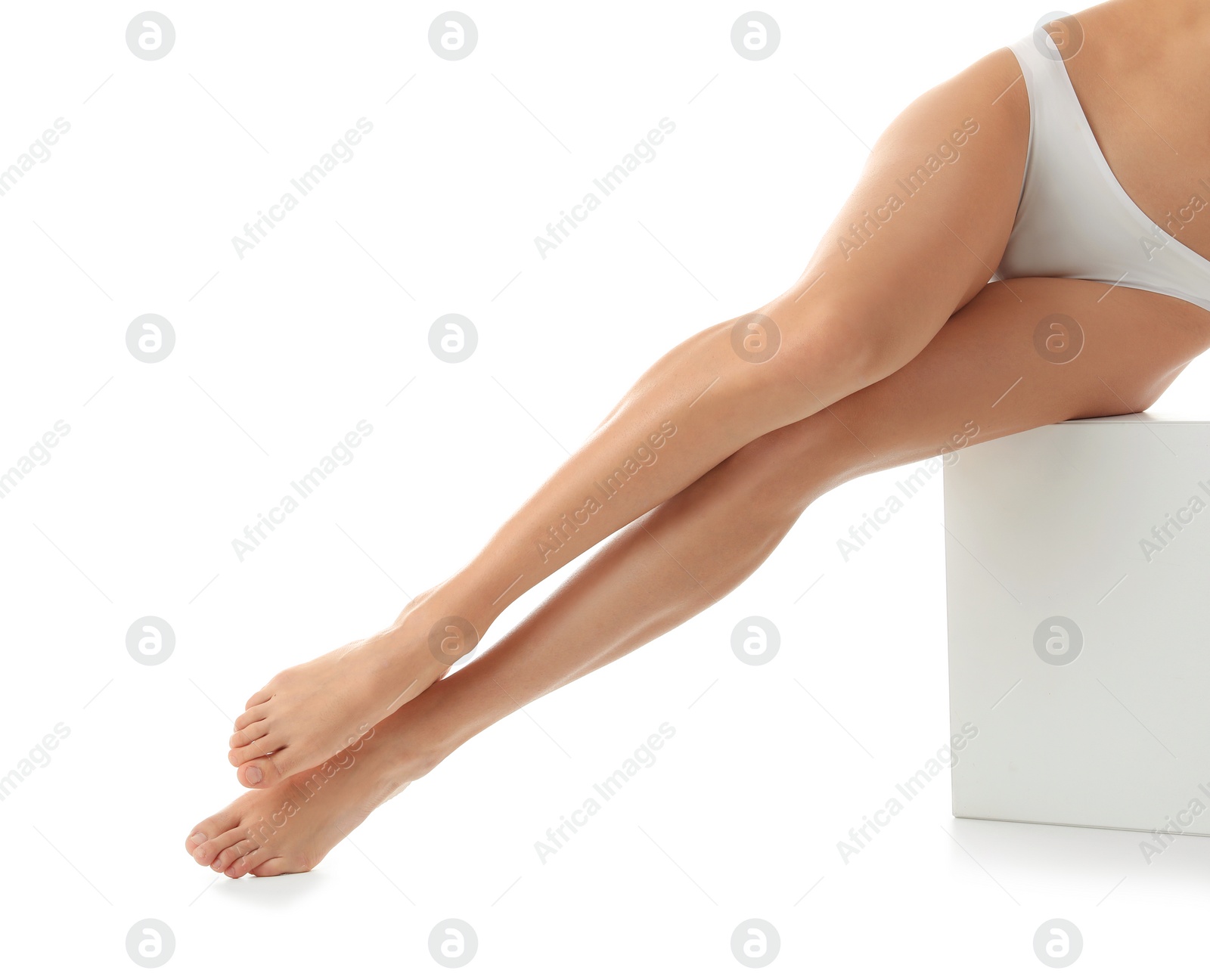 Photo of Young woman with beautiful long legs on white background, closeup