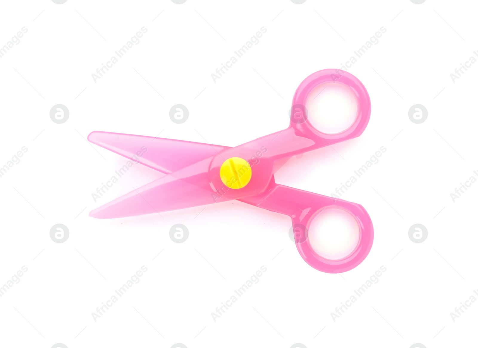 Photo of Pink plastic scissors on white background. Stationery for school