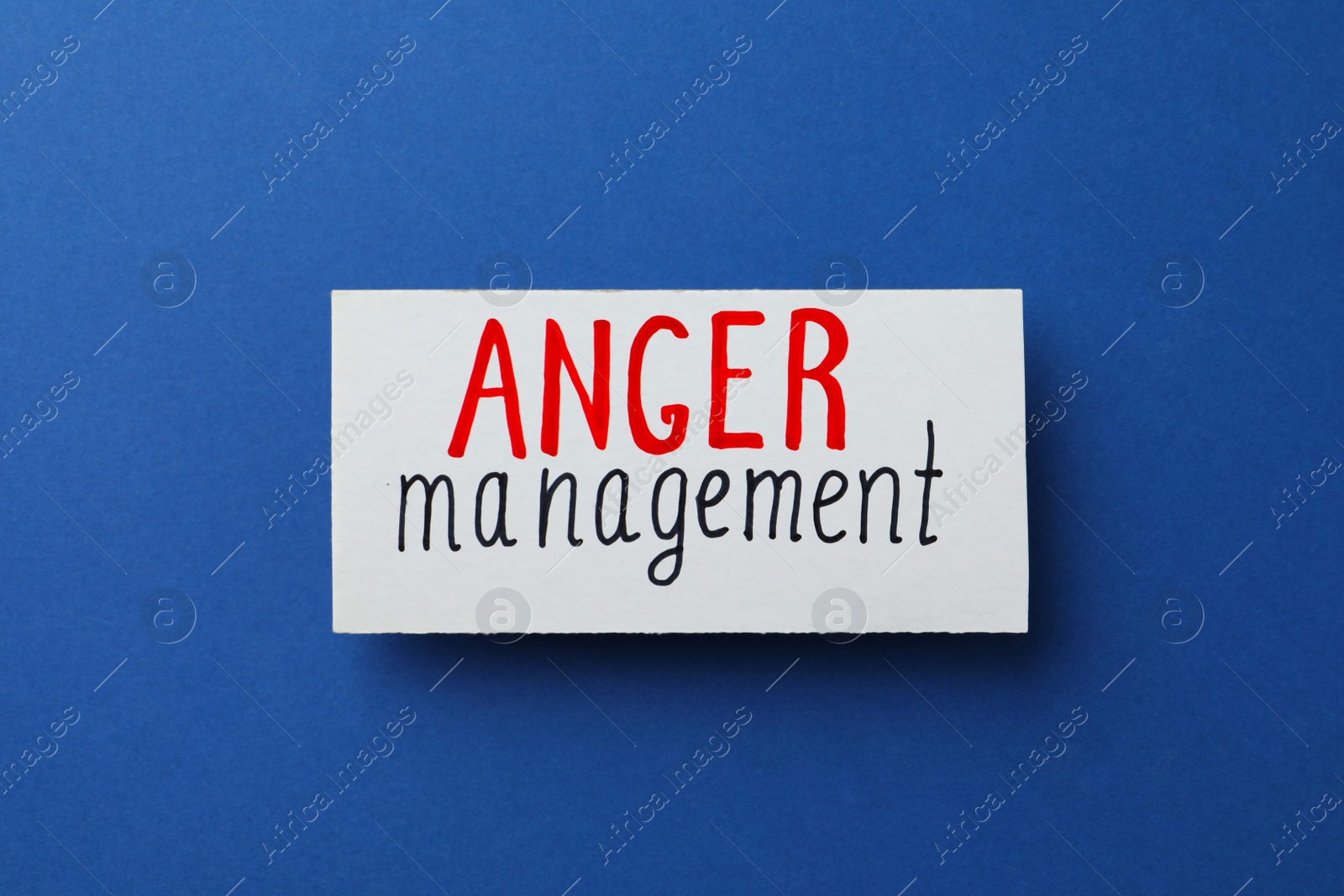 Photo of Card with words Anger Management on blue background, top view