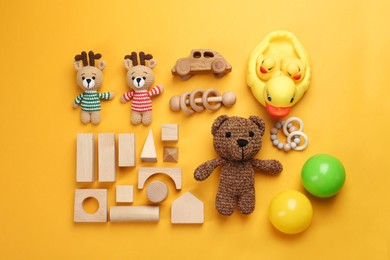 Different children's toys on yellow background, flat lay