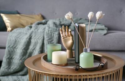 Stylish tray with different interior elements on table in living room