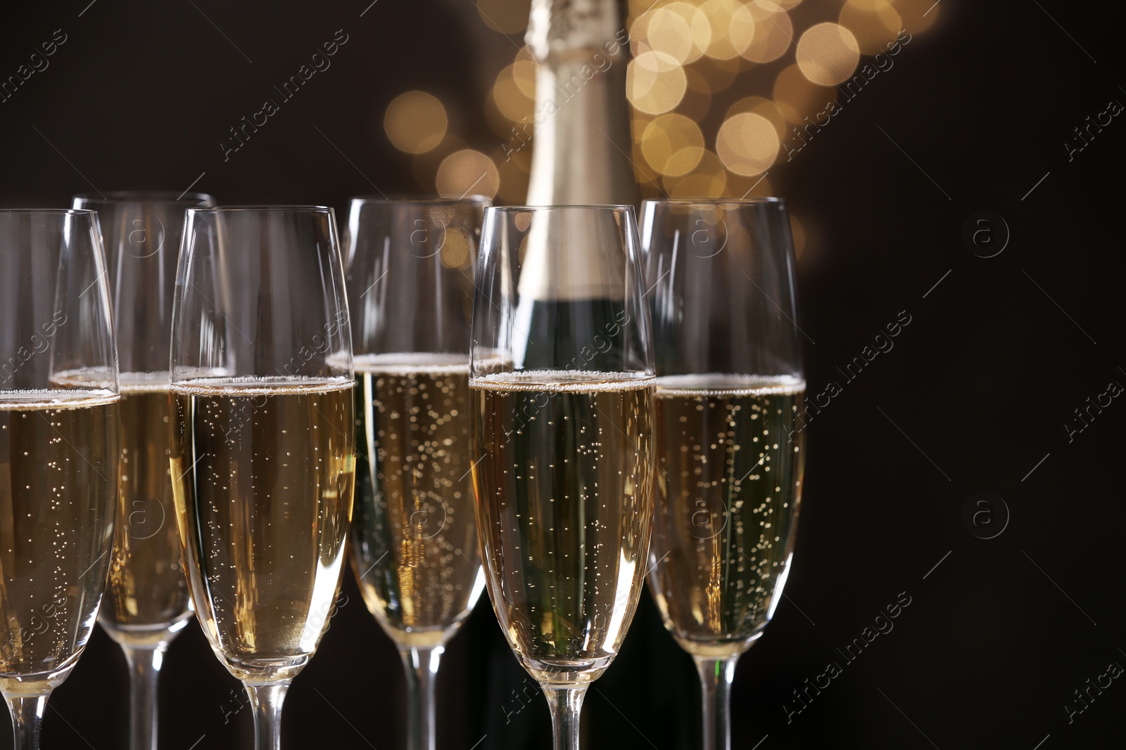 Photo of Glasses of champagne on blurred background, closeup. Space for text