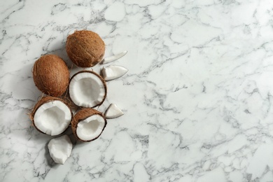 Flat lay composition with coconuts a on marble table. Space for text