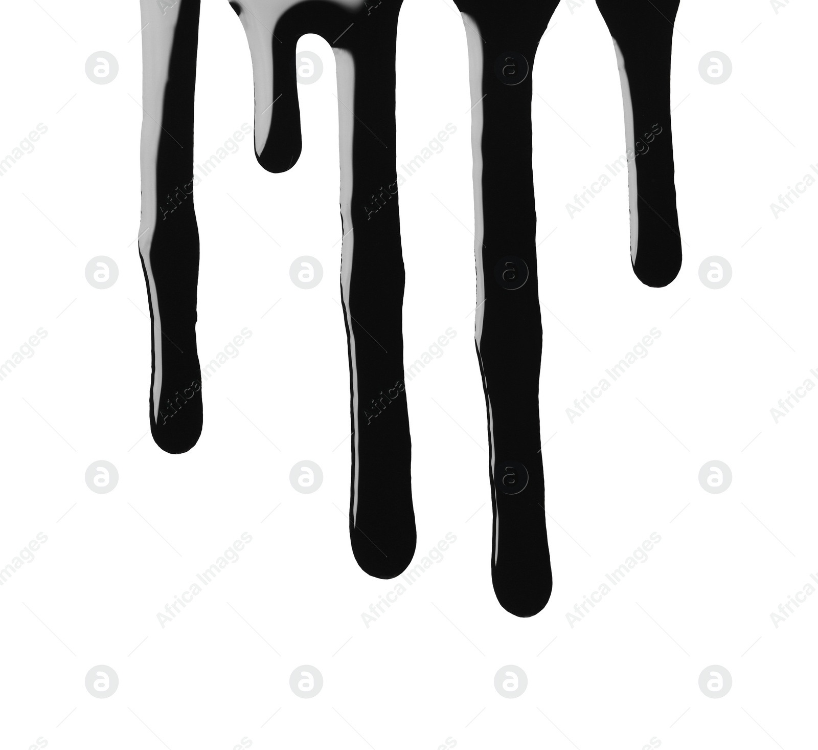 Photo of Black glossy oil flowing on white background