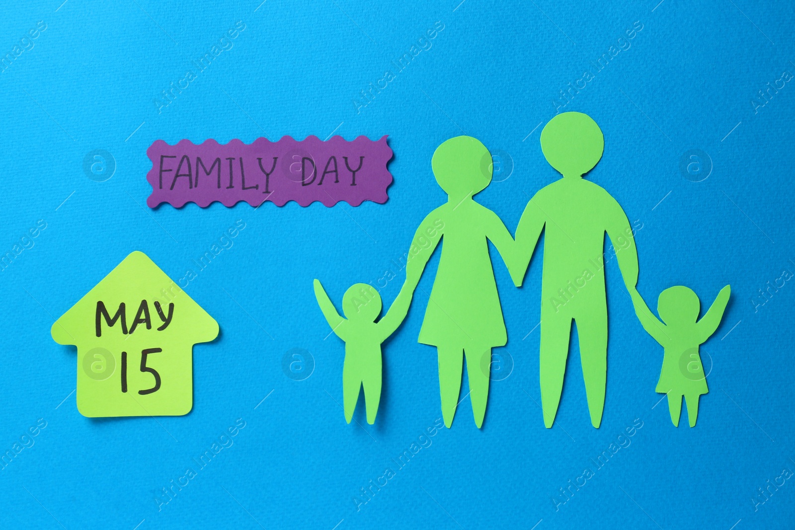 Photo of Card with text Family Day and paper cutouts on light blue background, flat lay