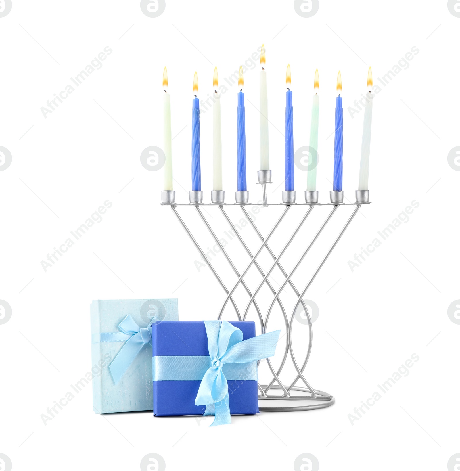 Photo of Hanukkah celebration. Menorah with candles and gift boxes isolated on white