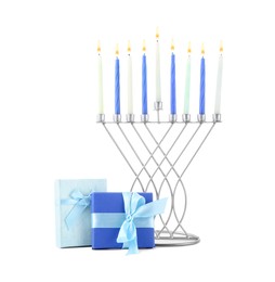 Hanukkah celebration. Menorah with candles and gift boxes isolated on white