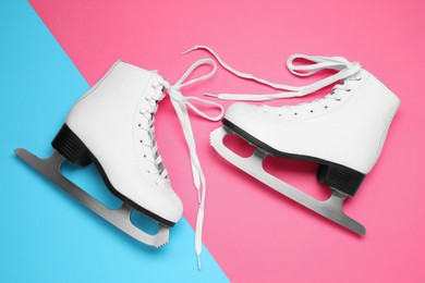 Photo of Pair of skates on color background, flat lay