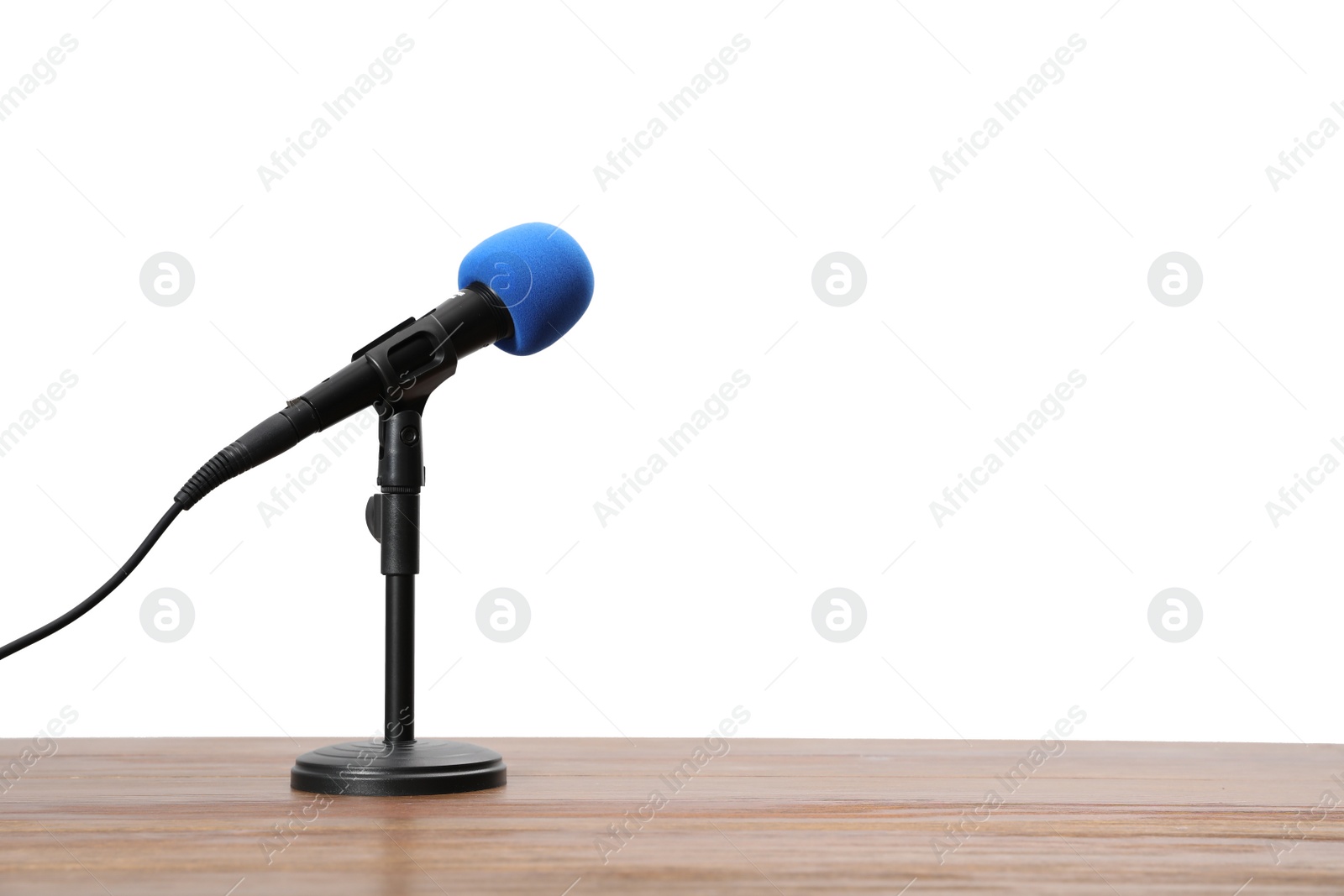 Photo of Modern microphone on wooden table, space for text. Journalist's equipment