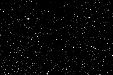 Photo of White snow falling down on black background