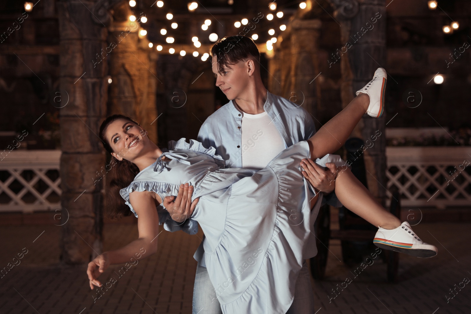 Photo of Beautiful young couple practicing dance moves in evening outdoors