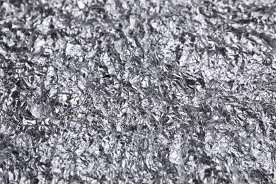 Crumpled silver foil as background, closeup view