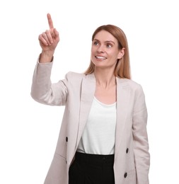 Beautiful happy businesswoman pointing at something on white background