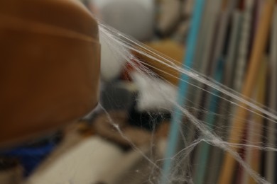 Photo of Old cobweb on table in room, closeup