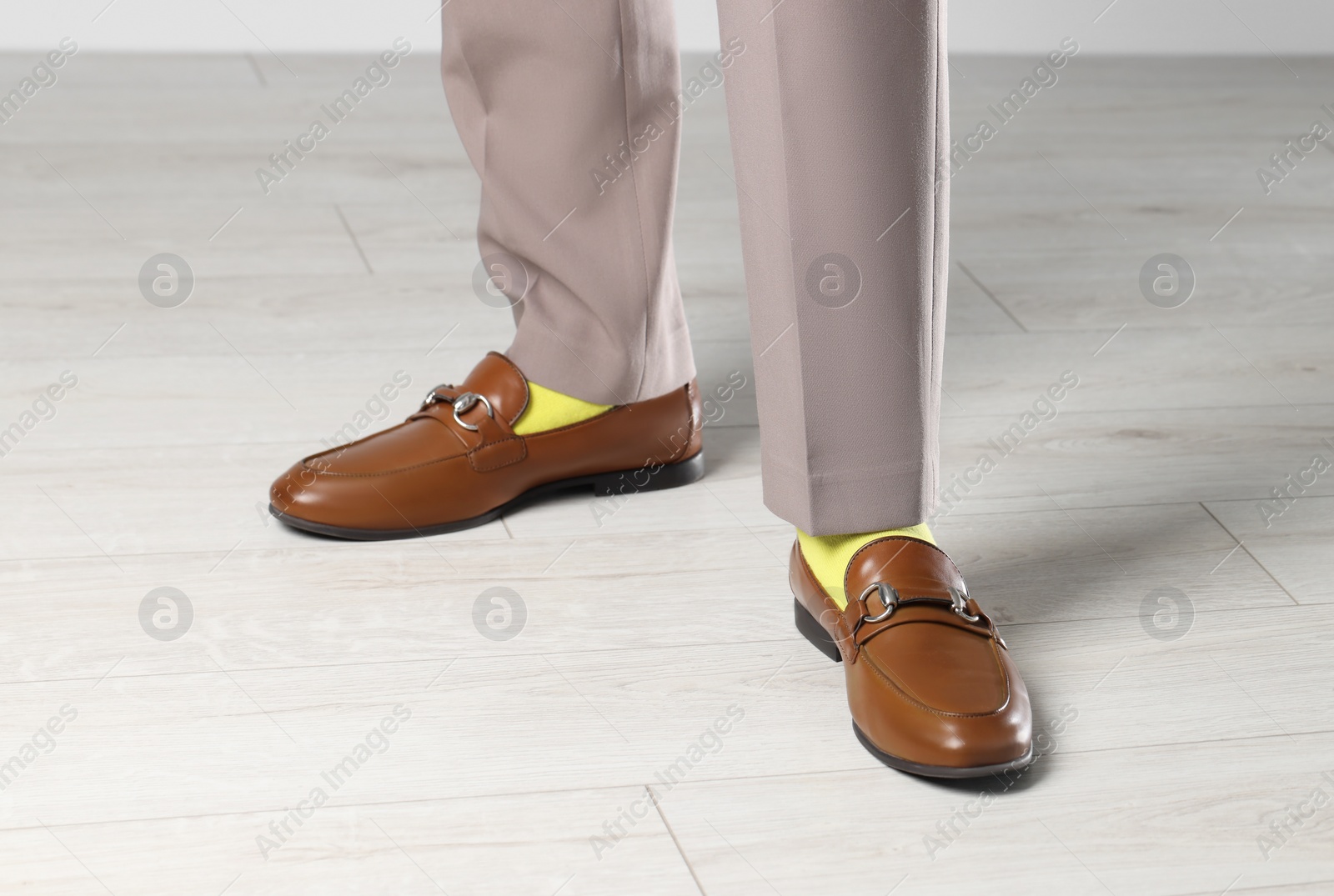 Photo of Man wearing stylish shoes and yellow socks indoors, closeup